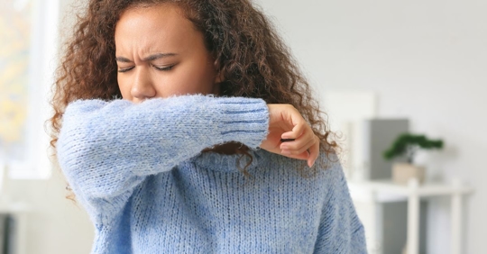 woman sneezing